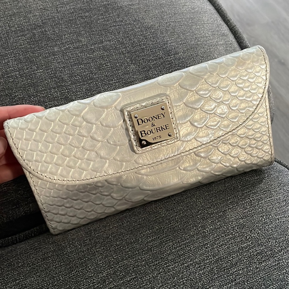 Pearl colored tri-fold wallet. Dooney & Bourke